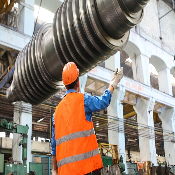 Safety professional inspecting industrial equipment on site