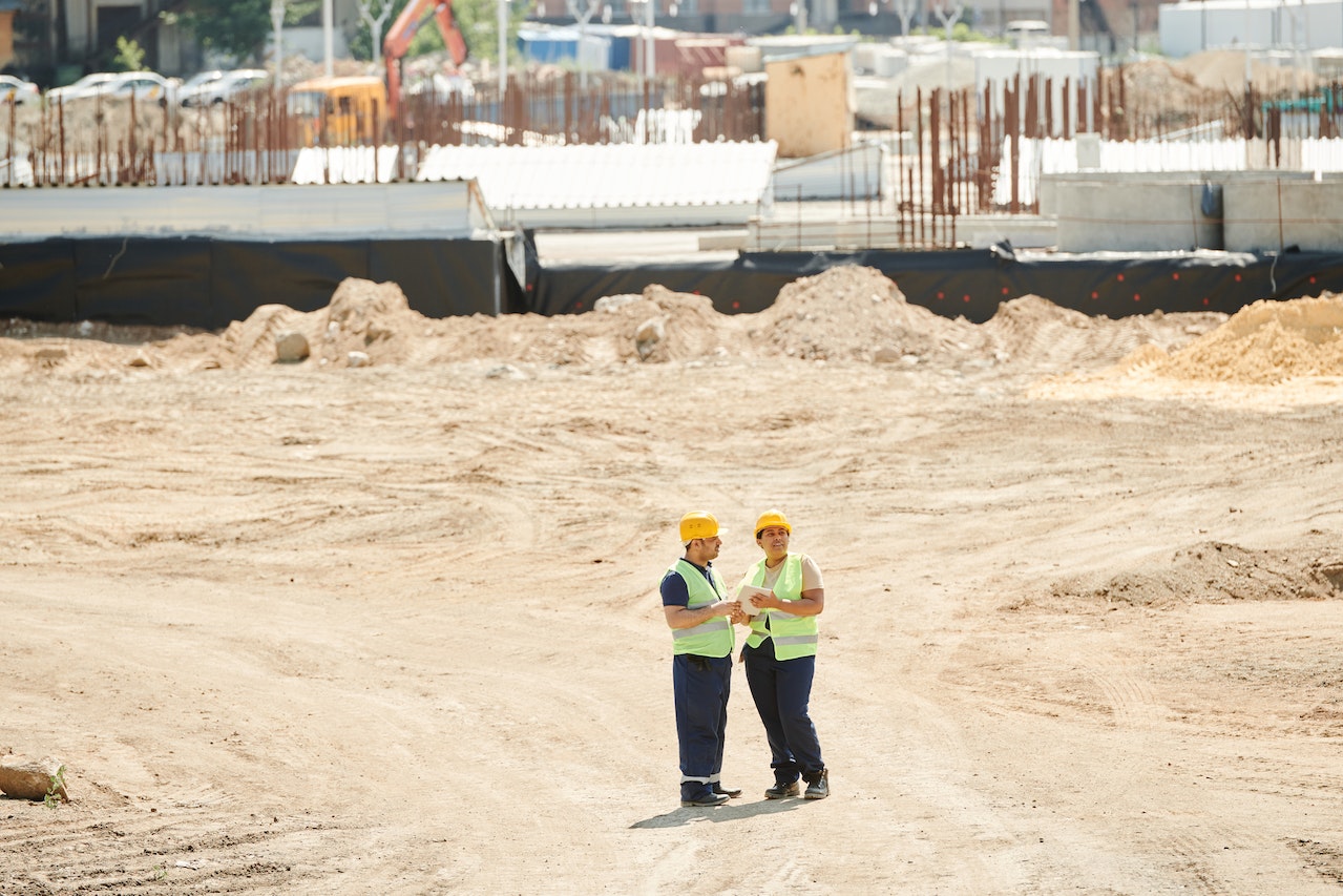 Construction workers in hi-vis and hard hats on a site safety course
